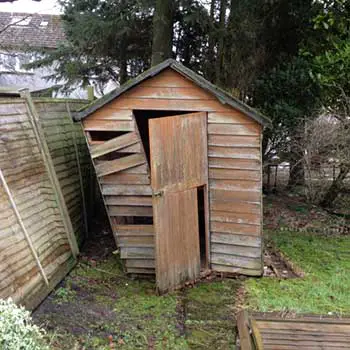 wooden shed struck by wind